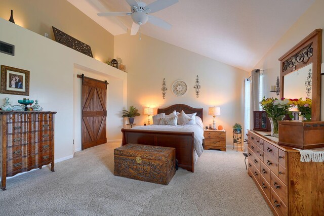 bedroom with visible vents, vaulted ceiling, a barn door, light carpet, and baseboards