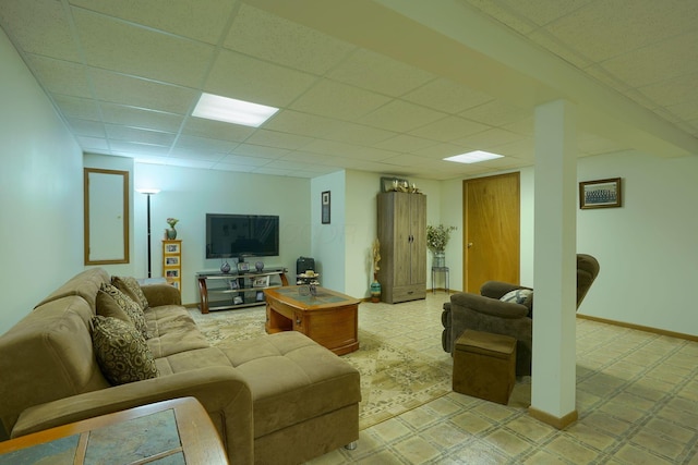 living area featuring a drop ceiling