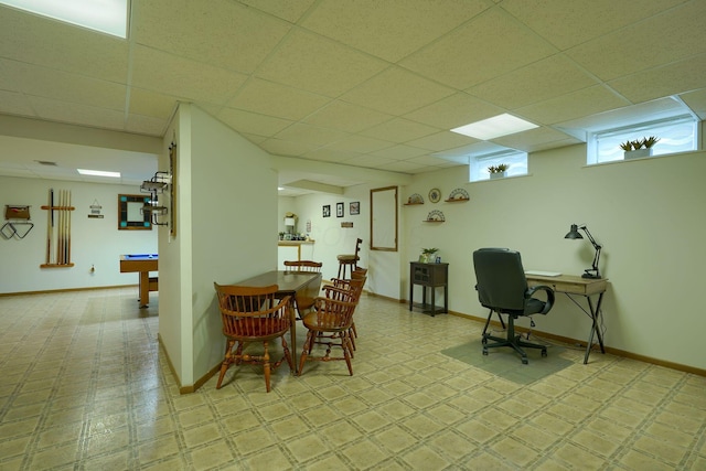 dining room with baseboards and a drop ceiling