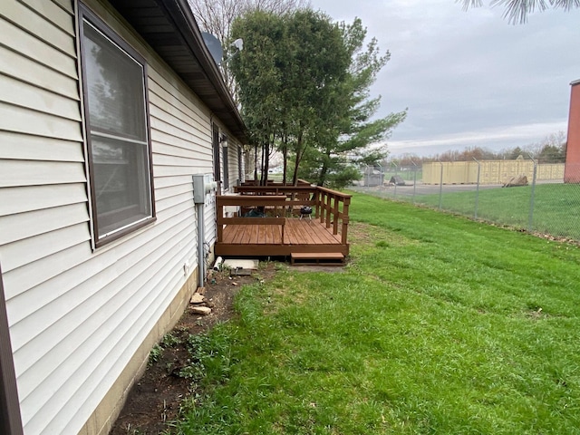 view of yard with a wooden deck and fence