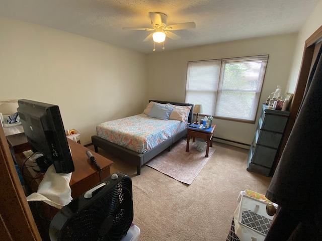 bedroom featuring a baseboard radiator, a ceiling fan, and carpet floors