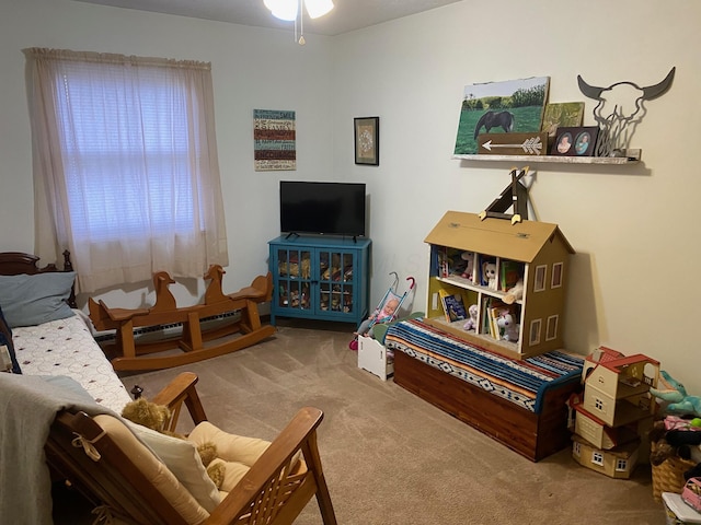 living area with a ceiling fan and carpet floors