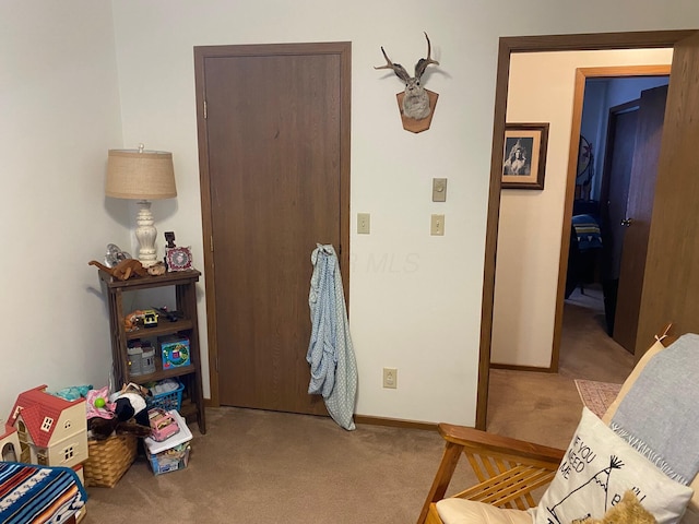interior space featuring carpet floors and baseboards