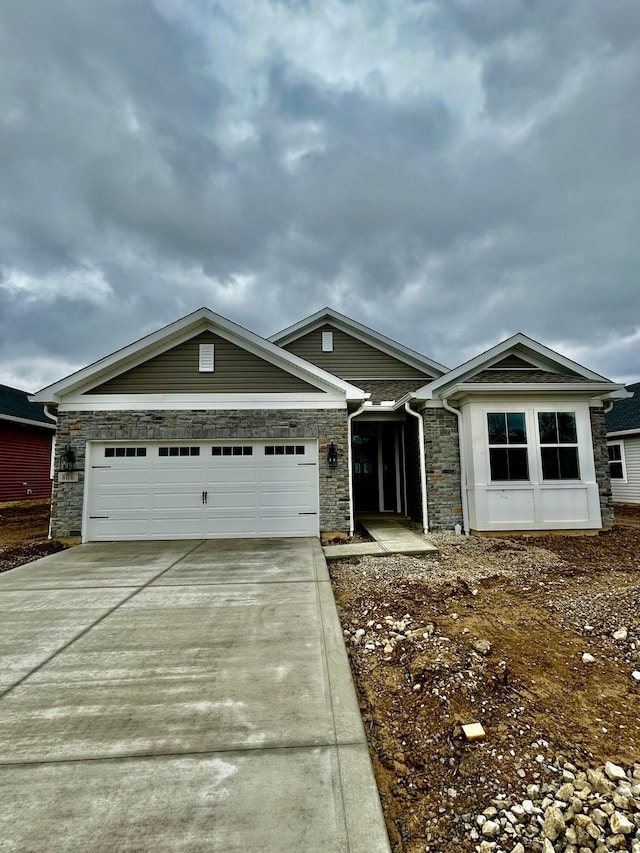 single story home featuring stone siding, driveway, and a garage
