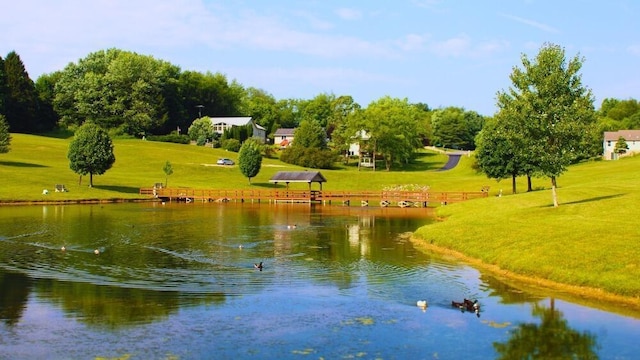 view of community featuring a yard and a water view