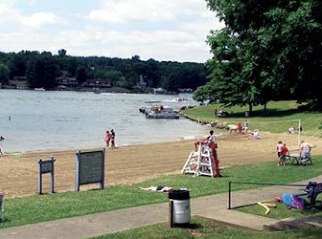 view of property's community featuring a water view and a lawn