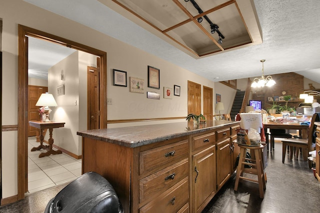2520 Mccutcheon Rd, Columbus, OH 43219 - bar with an inviting chandelier, a textured ceiling, stairs, decorative light fixtures, and baseboards