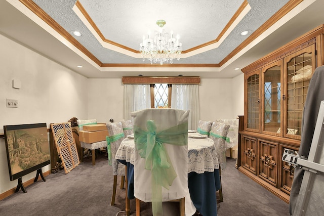 2520 Mccutcheon Rd, Columbus, OH 43219 - dining area with dark colored carpet, crown molding, a tray ceiling, and an inviting chandelier