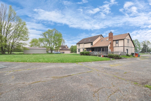 2520 Mccutcheon Rd, Columbus, OH 43219 - rear view of property with a lawn, a chimney, and stucco siding