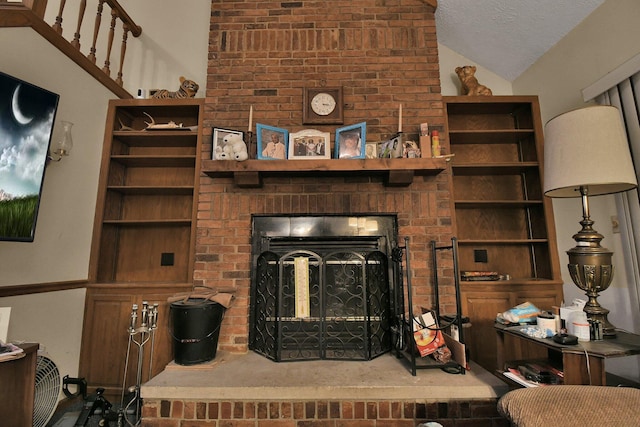 2520 Mccutcheon Rd, Columbus, OH 43219 - living room featuring built in features, a textured ceiling, and lofted ceiling