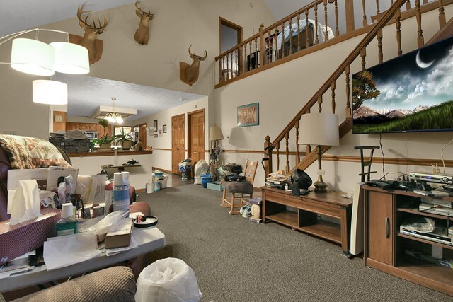 2520 Mccutcheon Rd, Columbus, OH 43219 - carpeted living room with a towering ceiling and a notable chandelier