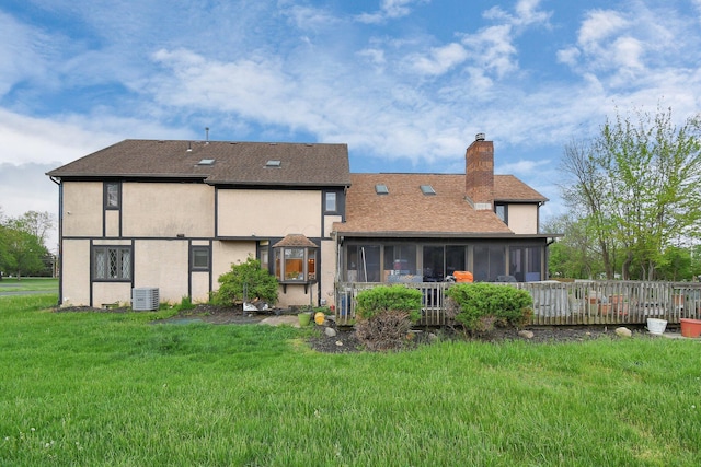 2520 Mccutcheon Rd, Columbus, OH 43219 - back of house featuring stucco siding, a sunroom, central AC unit, a chimney, and a yard