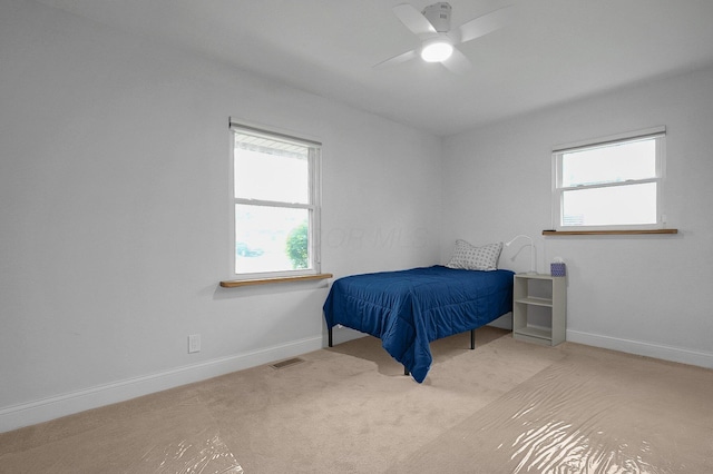 bedroom with visible vents, a ceiling fan, carpet flooring, and baseboards