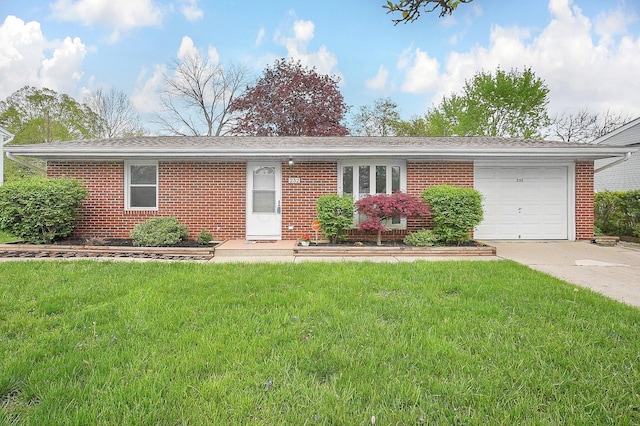 ranch-style house with a front yard, concrete driveway, a garage, and brick siding