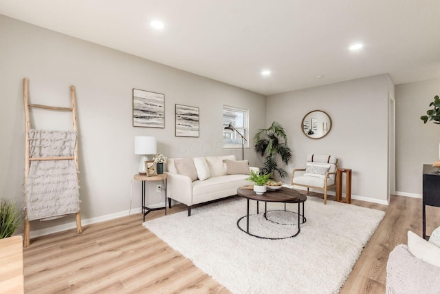 living area with baseboards, light wood-style floors, and recessed lighting