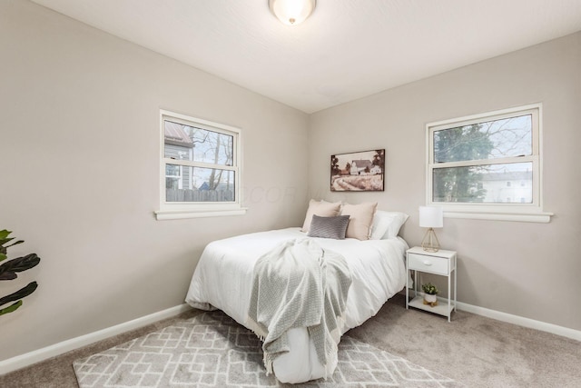 carpeted bedroom featuring baseboards
