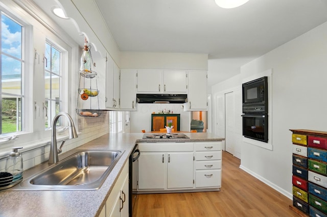 105 Chapin Pl, Granville, OH 43023 - kitchen featuring a sink, black appliances, light wood-style flooring, white cabinetry, and ventilation hood