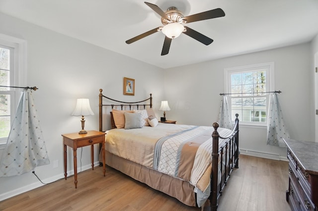 105 Chapin Pl, Granville, OH 43023 - bedroom with baseboards, light wood-type flooring, baseboard heating, and ceiling fan