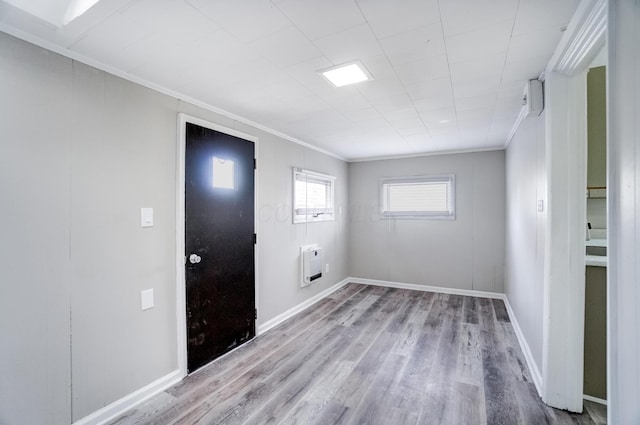 153 N High St, Mount Victory, OH 43340 - spare room featuring heating unit, ornamental molding, baseboards, and wood finished floors