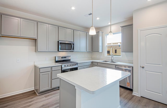 5537 Violet St Lot 367, South Bloomfield, OH 43103 - kitchen with appliances with stainless steel finishes, gray cabinetry, light wood-style floors, light countertops, and a center island