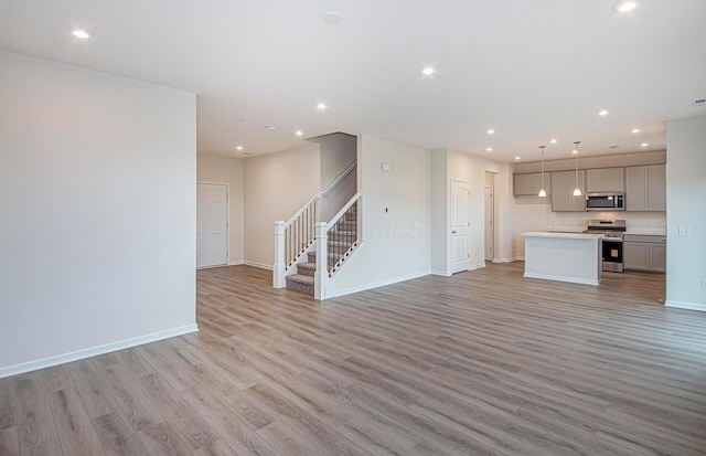 5537 Violet St Lot 367, South Bloomfield, OH 43103 - unfurnished living room featuring light wood-style flooring, stairway, and recessed lighting