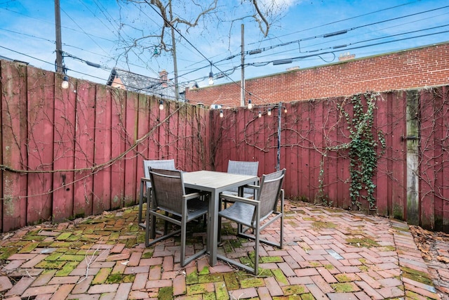 view of patio with a fenced backyard and outdoor dining area