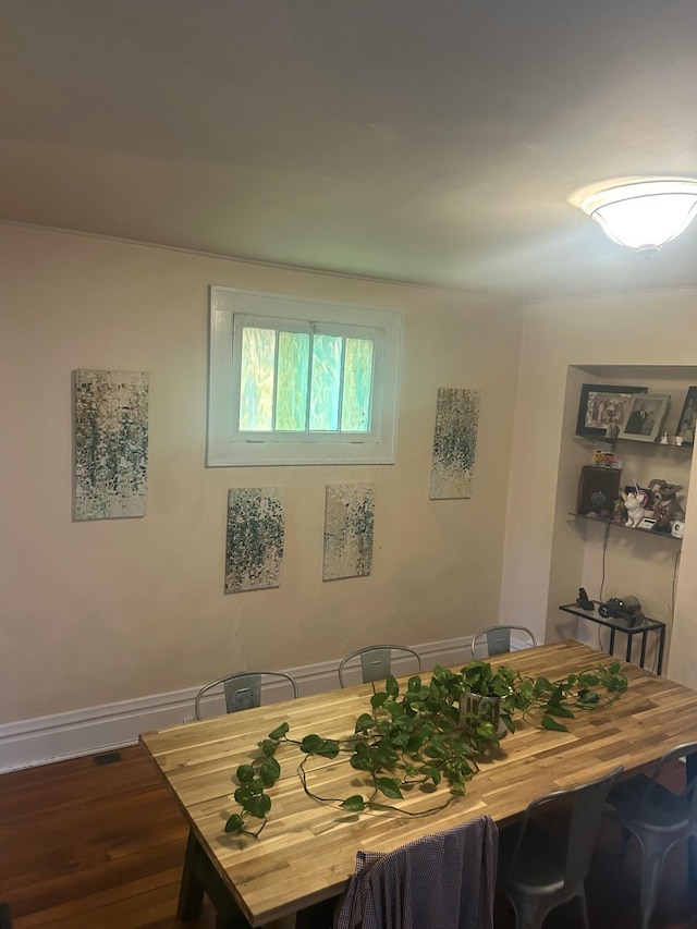 dining room featuring wood finished floors and baseboards