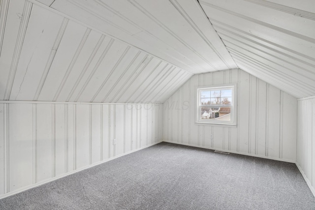 bonus room with carpet, vaulted ceiling, and visible vents