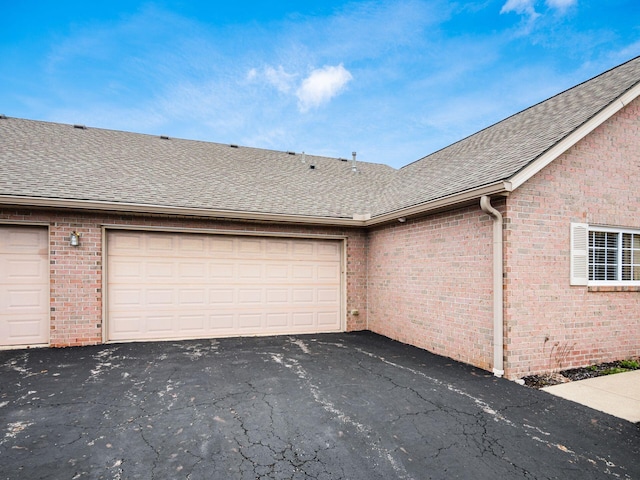 garage with aphalt driveway