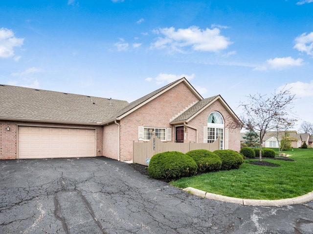 view of front of home featuring brick siding, an attached garage, and aphalt driveway