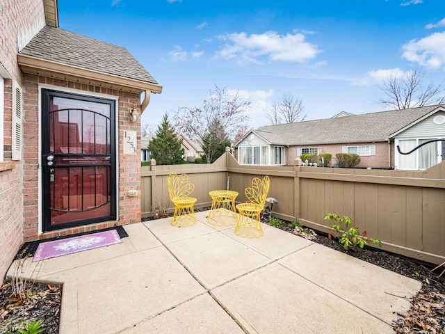 view of patio featuring fence