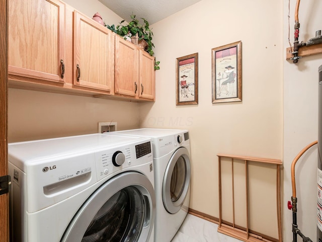 washroom with cabinet space, baseboards, marble finish floor, and separate washer and dryer