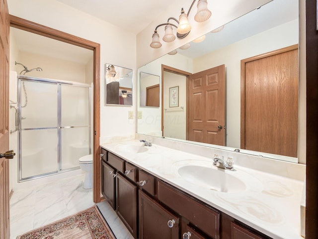 bathroom with a shower stall, marble finish floor, a sink, and toilet