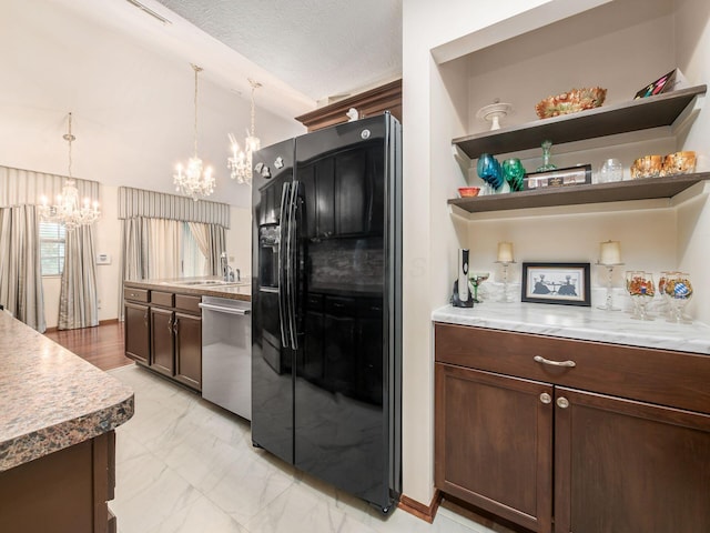 kitchen featuring a notable chandelier, black fridge with ice dispenser, dishwasher, marble finish floor, and lofted ceiling