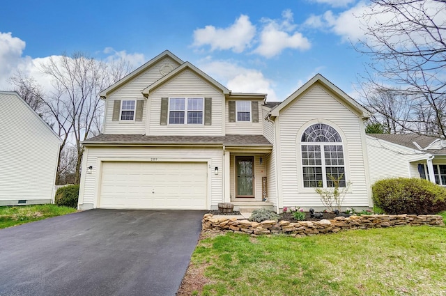 traditional home with an attached garage and aphalt driveway