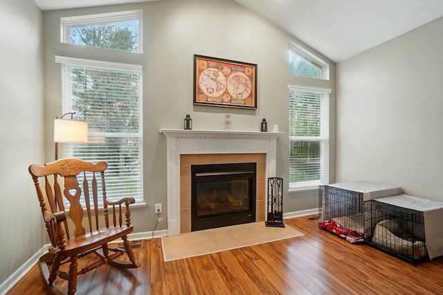 sitting room featuring a wealth of natural light, baseboards, a fireplace, and wood finished floors