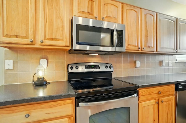 kitchen with light brown cabinets, stainless steel appliances, and tasteful backsplash