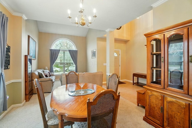 dining area featuring a chandelier, light carpet, baseboards, ornamental molding, and ornate columns