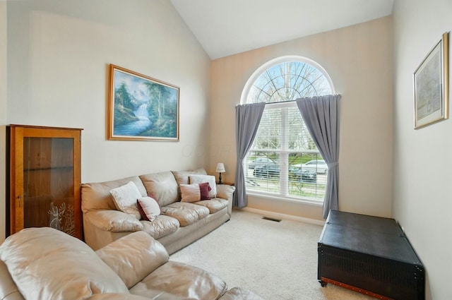 living room featuring visible vents, lofted ceiling, and carpet floors