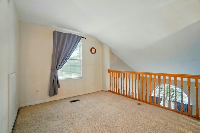 bonus room with carpet floors, baseboards, visible vents, and lofted ceiling