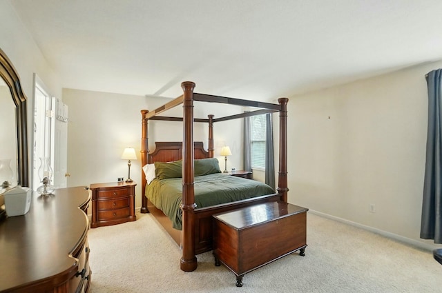 bedroom featuring light carpet and baseboards