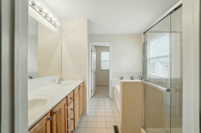 bathroom featuring tile patterned floors, a sink, a garden tub, a shower with shower door, and double vanity