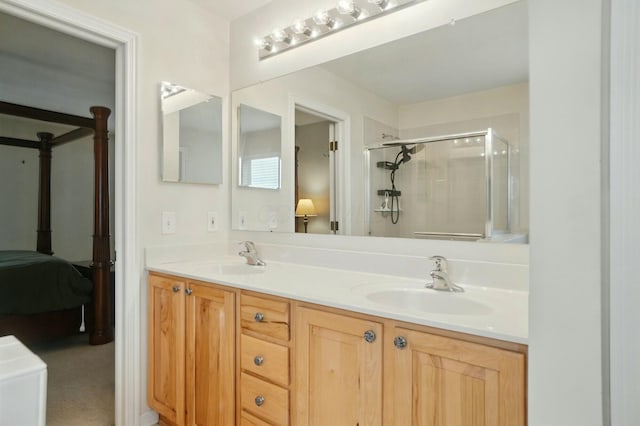 ensuite bathroom featuring double vanity, a sink, a stall shower, and ensuite bathroom