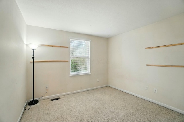 carpeted spare room with baseboards and visible vents