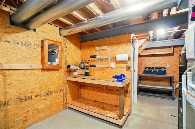 unfinished basement featuring a workshop area