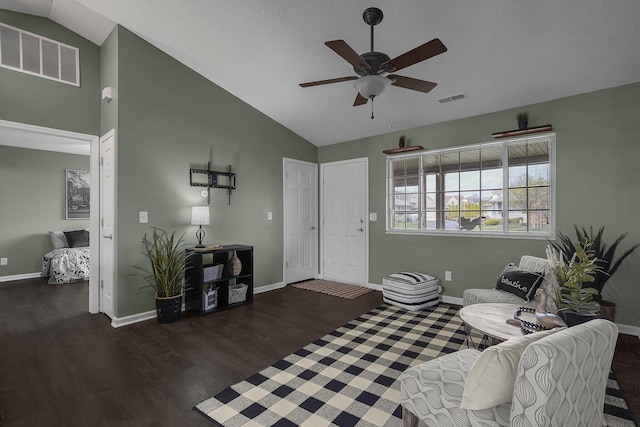 living room featuring baseboards, visible vents, wood finished floors, and a ceiling fan