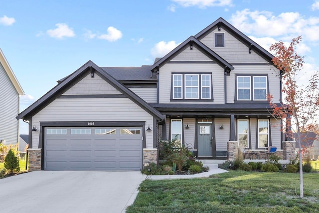 6003 Honey Farm Way, Grove City, OH 43123 - craftsman house with an attached garage, stone siding, driveway, a front lawn, and a porch