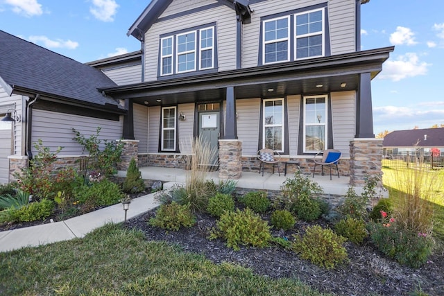 6003 Honey Farm Way, Grove City, OH 43123 - craftsman house featuring stone siding, covered porch, and fence