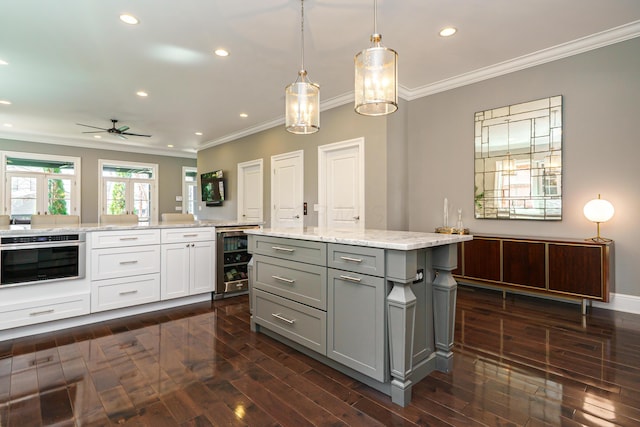 251 E Deshler Ave, Columbus, OH 43206 - kitchen with stainless steel oven, crown molding, gray cabinets, and wine cooler