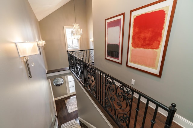 251 E Deshler Ave, Columbus, OH 43206 - stairs with vaulted ceiling, an inviting chandelier, wood finished floors, and baseboards